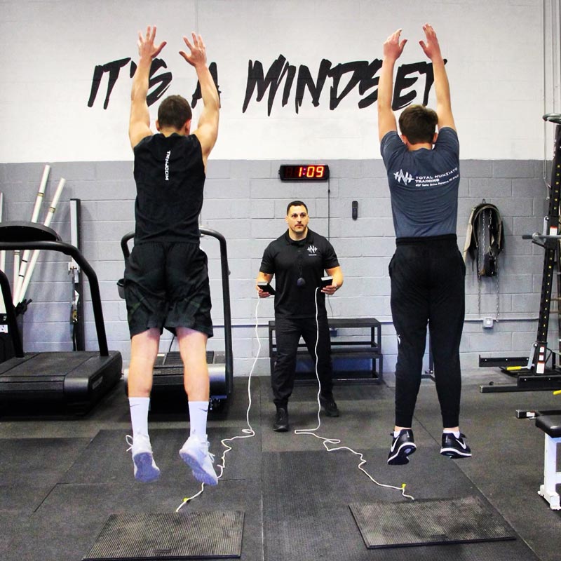 Athletes doing vertical jump testing with a coach during personal training at TNT Training in New Jersey.